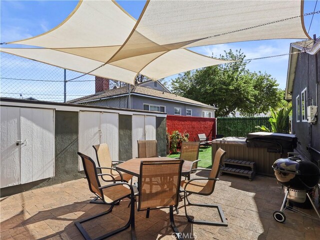 8110 Lesner Ave, Lake Balboa, CA 91406 - view of patio featuring a hot tub, outdoor dining area, grilling area, and a storage shed