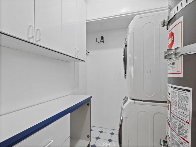 8110 Lesner Ave, Lake Balboa, CA 91406 - washroom featuring stacked washer / drying machine, secured water heater, and cabinet space