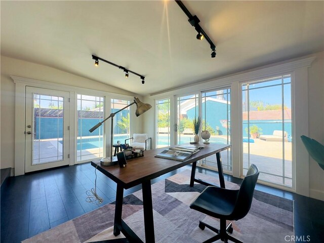 8110 Lesner Ave, Lake Balboa, CA 91406 - home office featuring rail lighting, healthy amount of natural light, wood finished floors, and vaulted ceiling