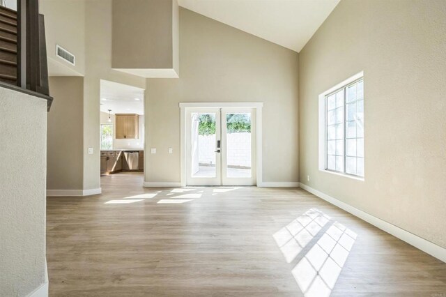40550 Ventana Ct, Palm Desert, CA 92260 - spare room featuring high vaulted ceiling, french doors, baseboards, and light wood finished floors