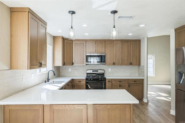 40550 Ventana Ct, Palm Desert, CA 92260 - kitchen featuring appliances with stainless steel finishes, a sink, light wood-style flooring, decorative backsplash, and light countertops