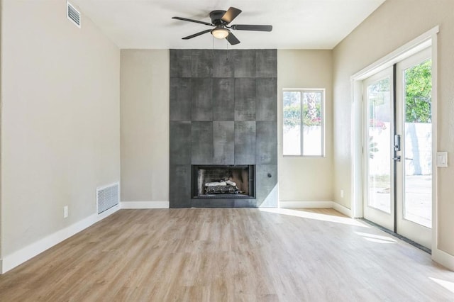 40550 Ventana Ct, Palm Desert, CA 92260 - unfurnished living room featuring a fireplace, wood finished floors, a ceiling fan, and baseboards