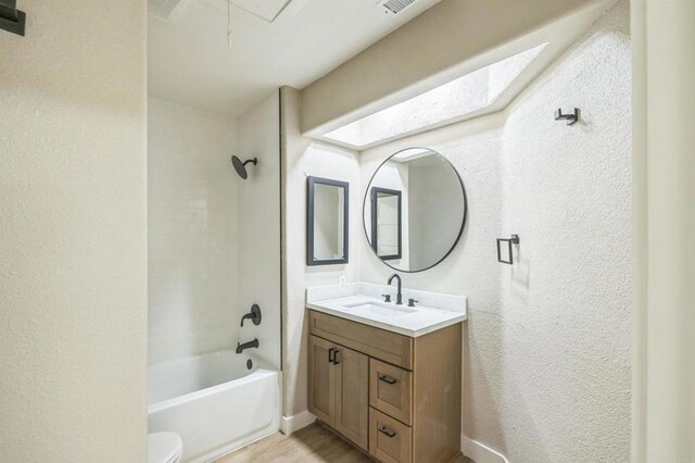 40550 Ventana Ct, Palm Desert, CA 92260 - bathroom with a textured wall, vanity, shower / washtub combination, toilet, and wood finished floors