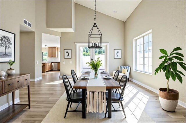 40550 Ventana Ct, Palm Desert, CA 92260 - dining space with high vaulted ceiling, light wood-style floors, and baseboards