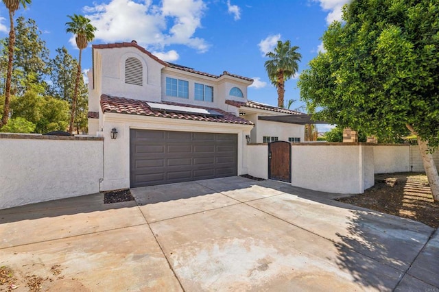 40550 Ventana Ct, Palm Desert, CA 92260 - mediterranean / spanish-style house featuring a gate, driveway, a tile roof, and stucco siding
