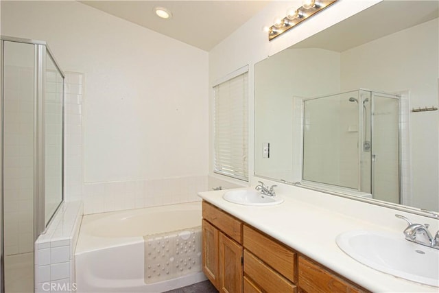 bathroom with a shower stall, a garden tub, and double vanity