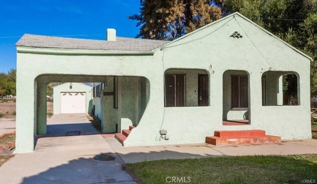 view of front of home featuring an attached garage, entry steps, stucco siding, and driveway