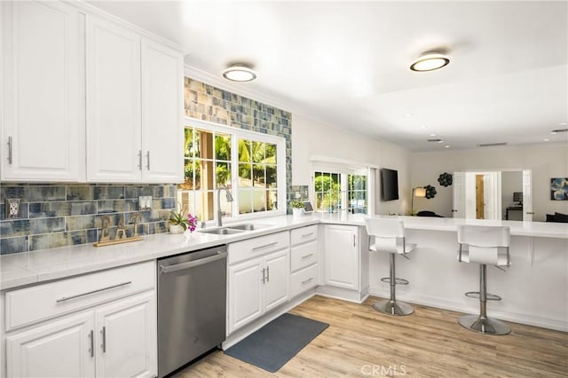 15541 Olive Branch Dr, La Mirada, CA 90638 - kitchen featuring dishwasher, a sink, backsplash, white cabinets, and light wood finished floors