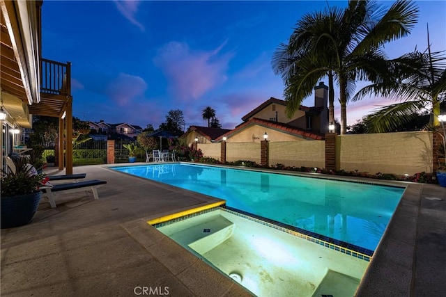 15541 Olive Branch Dr, La Mirada, CA 90638 - pool at dusk featuring an in-ground hot tub, a fenced backyard, and a patio