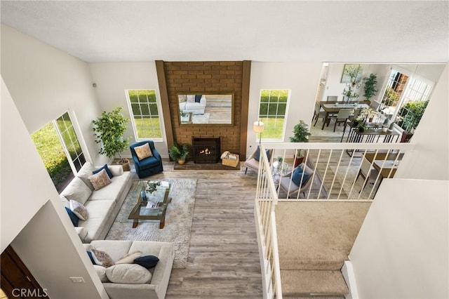 15541 Olive Branch Dr, La Mirada, CA 90638 - living area featuring wood finished floors, healthy amount of natural light, and a fireplace