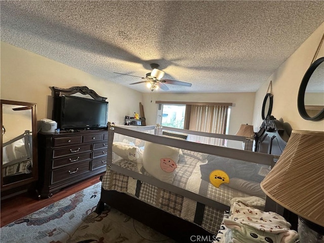 bedroom with dark wood-type flooring, a ceiling fan, and a textured ceiling