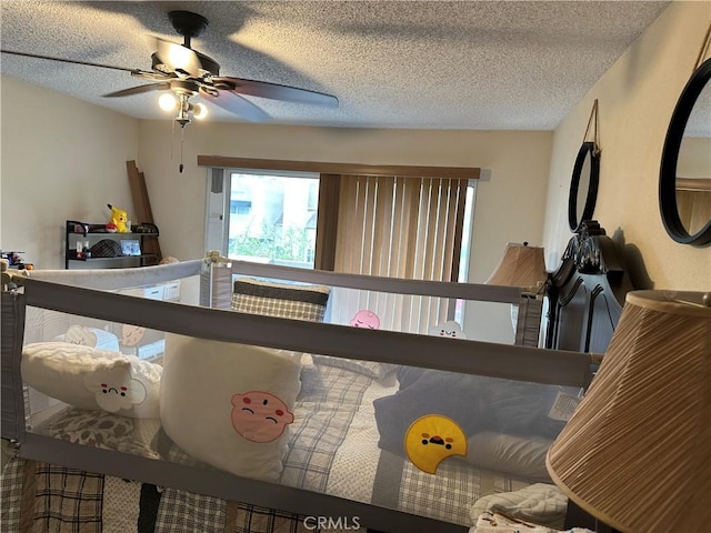 bedroom with a textured ceiling and a ceiling fan