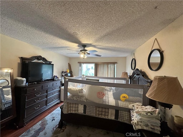 bedroom featuring dark wood-style flooring, a textured ceiling, and a ceiling fan