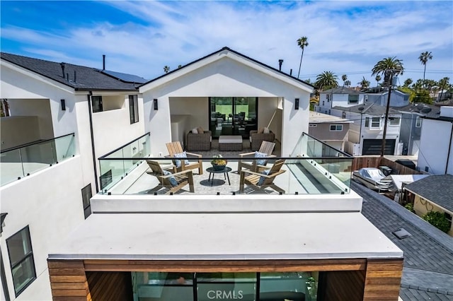 518 8th St, Huntington Beach, CA 92648 - back of property with stucco siding, a balcony, and outdoor lounge area