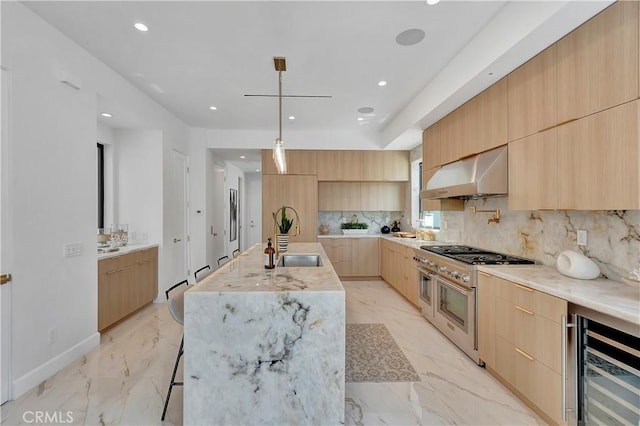 518 8th St, Huntington Beach, CA 92648 - kitchen with modern cabinets, range with two ovens, wine cooler, extractor fan, and light brown cabinetry