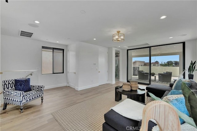 518 8th St, Huntington Beach, CA 92648 - living room with light wood-style floors, a chandelier, baseboards, and recessed lighting