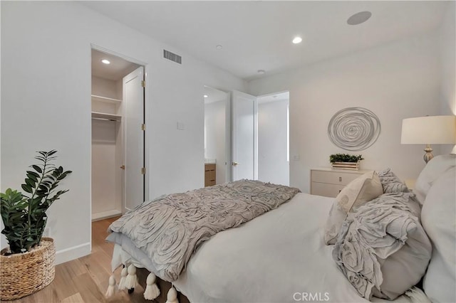 518 8th St, Huntington Beach, CA 92648 - bedroom with light wood-type flooring, a walk in closet, and recessed lighting