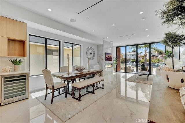 518 8th St, Huntington Beach, CA 92648 - dining space featuring wine cooler, light marble finish flooring, healthy amount of natural light, and recessed lighting