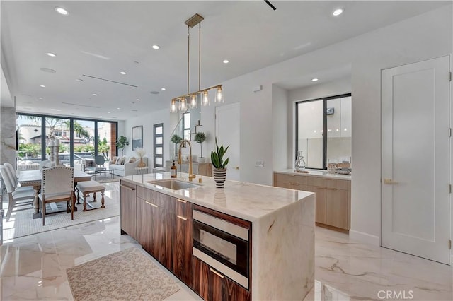 518 8th St, Huntington Beach, CA 92648 - kitchen featuring a sink, modern cabinets, built in microwave, light marble finish flooring, and recessed lighting