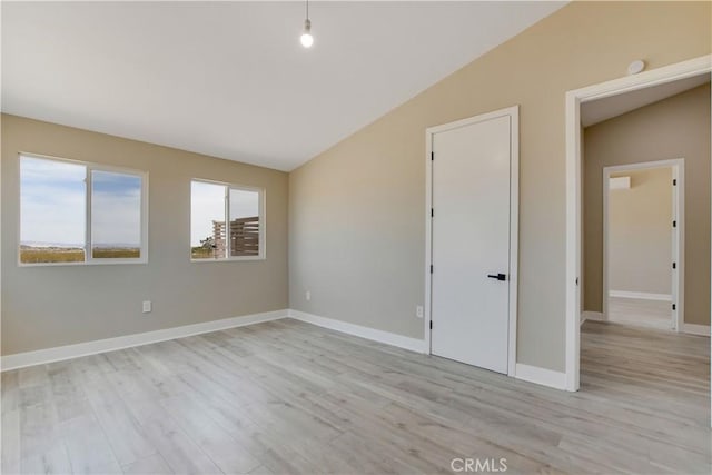 1809 Delgada Ave, Landers, CA 92285 - spare room with lofted ceiling, light wood finished floors, and baseboards