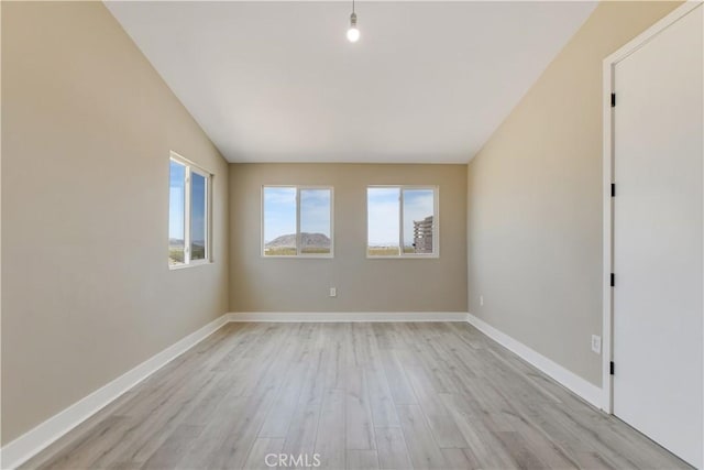 1809 Delgada Ave, Landers, CA 92285 - unfurnished room with light wood-style floors, baseboards, and vaulted ceiling