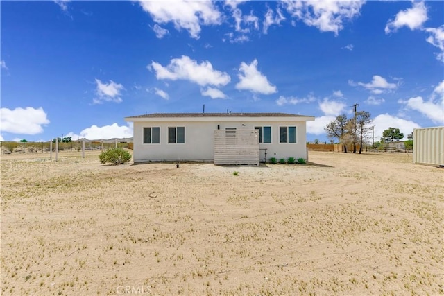 1809 Delgada Ave, Landers, CA 92285 - back of house with stucco siding and fence
