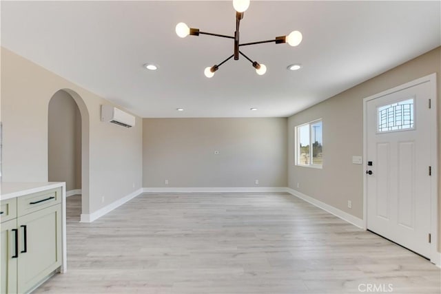 1809 Delgada Ave, Landers, CA 92285 - foyer featuring a chandelier, light wood finished floors, a wall mounted AC, arched walkways, and recessed lighting