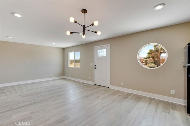 1809 Delgada Ave, Landers, CA 92285 - entrance foyer featuring a chandelier, light wood-type flooring, and baseboards