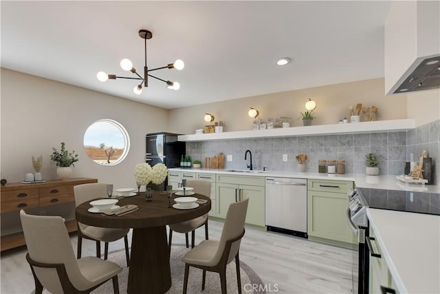 1809 Delgada Ave, Landers, CA 92285 - kitchen featuring stainless steel appliances, open shelves, green cabinetry, a sink, and wall chimney exhaust hood
