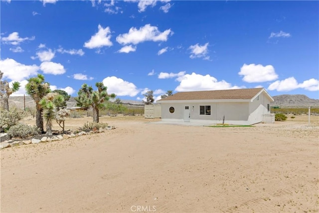 1809 Delgada Ave, Landers, CA 92285 - back of property featuring stucco siding