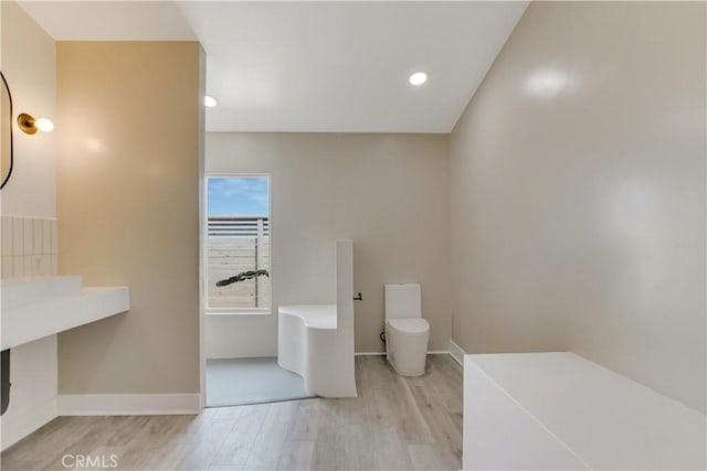 1809 Delgada Ave, Landers, CA 92285 - bathroom featuring wood finished floors, baseboards, recessed lighting, and toilet