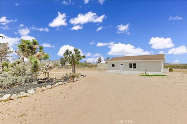 1809 Delgada Ave, Landers, CA 92285 - back of property with stucco siding