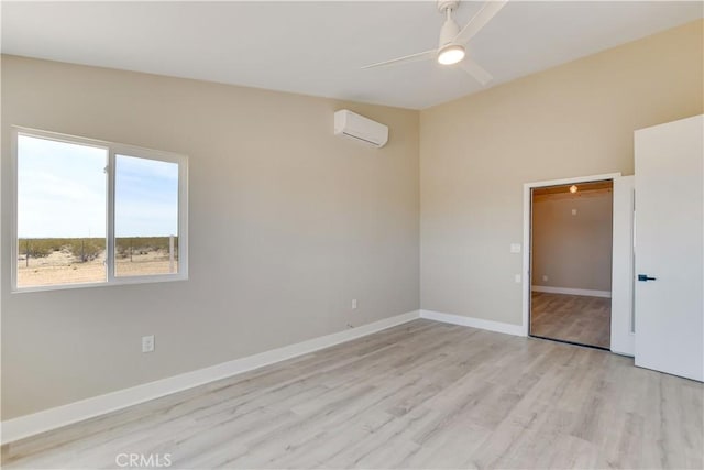 1809 Delgada Ave, Landers, CA 92285 - spare room with a wall mounted air conditioner, light wood-style flooring, ceiling fan, and baseboards