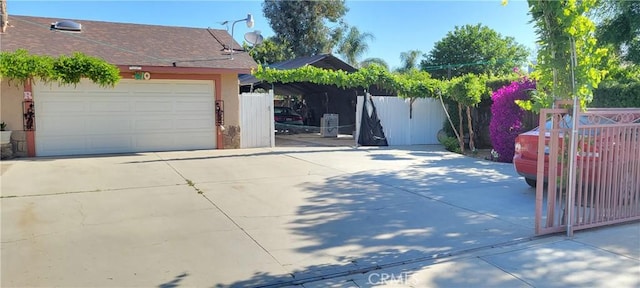 garage featuring fence and driveway
