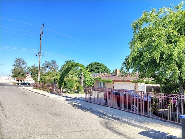 view of front facade with fence and a garage