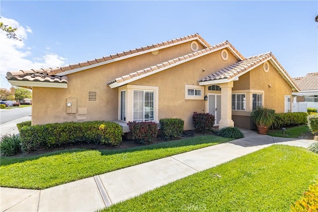 5470 Watson St, Banning, CA 92220 - view of front of house featuring a front yard, stucco siding, and a tiled roof