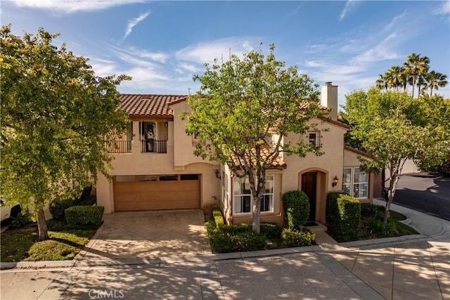 11803 Sortino Ct, Moorpark, CA 93021 - view of front facade featuring concrete driveway, stucco siding, an attached garage, a tile roof, and a balcony