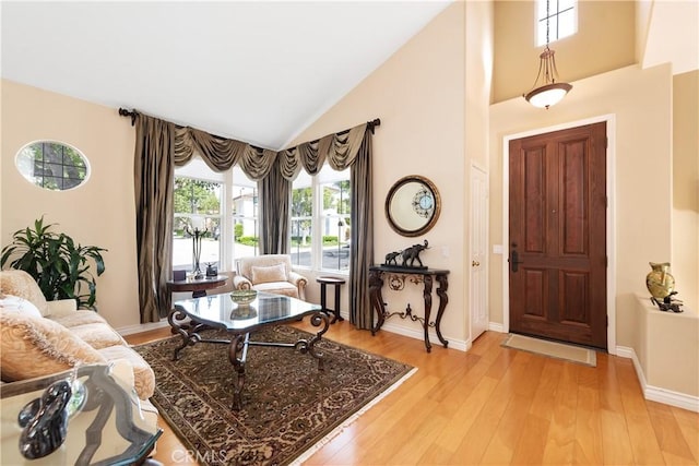 11803 Sortino Ct, Moorpark, CA 93021 - foyer featuring light wood-style floors, high vaulted ceiling, and baseboards