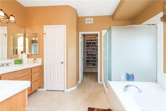 11803 Sortino Ct, Moorpark, CA 93021 - bathroom featuring a stall shower, vanity, a garden tub, and a spacious closet