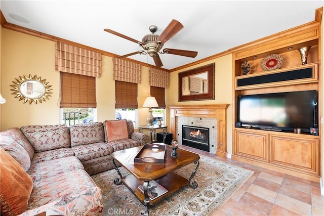 11803 Sortino Ct, Moorpark, CA 93021 - living room featuring a ceiling fan, crown molding, a tile fireplace, and built in shelves