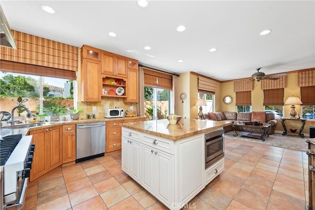 11803 Sortino Ct, Moorpark, CA 93021 - kitchen with stainless steel appliances, a sink, light stone countertops, recessed lighting, and ceiling fan