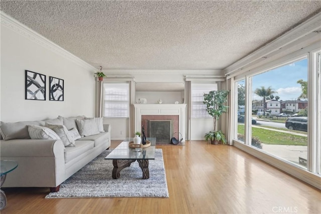 1845 W 91st Pl, Los Angeles, CA 90047 - living room with crown molding, a textured ceiling, wood finished floors, and a fireplace