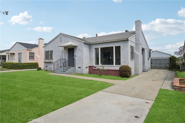 1845 W 91st Pl, Los Angeles, CA 90047 - view of front facade featuring stucco siding, a front lawn, a chimney, and concrete driveway