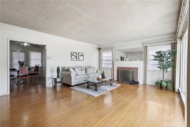 1845 W 91st Pl, Los Angeles, CA 90047 - living room with a textured ceiling, crown molding, wood finished floors, and a brick fireplace