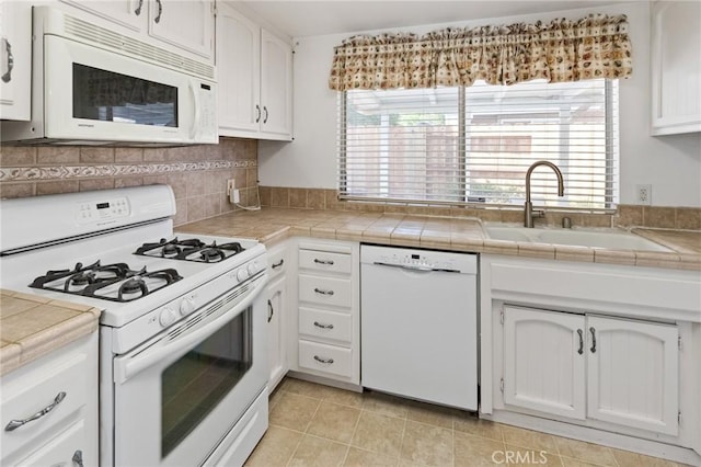 349 Silver Star Ct, Merced, CA 95348 - kitchen featuring white appliances, a sink, white cabinetry, tile counters, and decorative backsplash