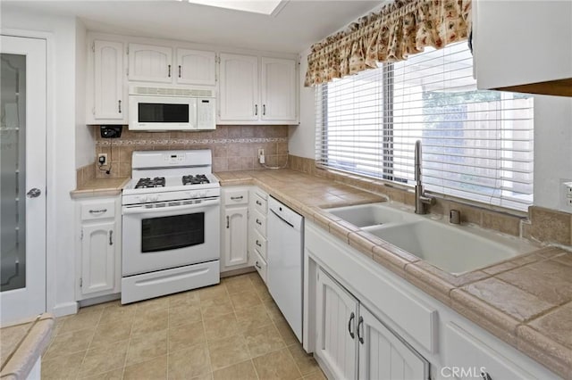 349 Silver Star Ct, Merced, CA 95348 - kitchen featuring white appliances, a sink, white cabinets, tile countertops, and light tile patterned floors