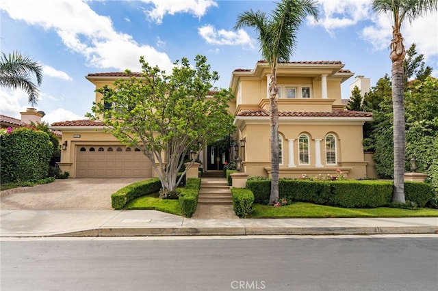 20112 Via Cellini, Porter Ranch, CA 91311 - mediterranean / spanish house featuring stucco siding, decorative driveway, a tile roof, and an attached garage