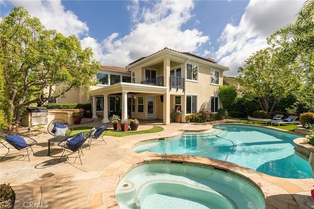 20112 Via Cellini, Porter Ranch, CA 91311 - view of pool featuring a patio area, an outdoor kitchen, a pool with connected hot tub, and grilling area