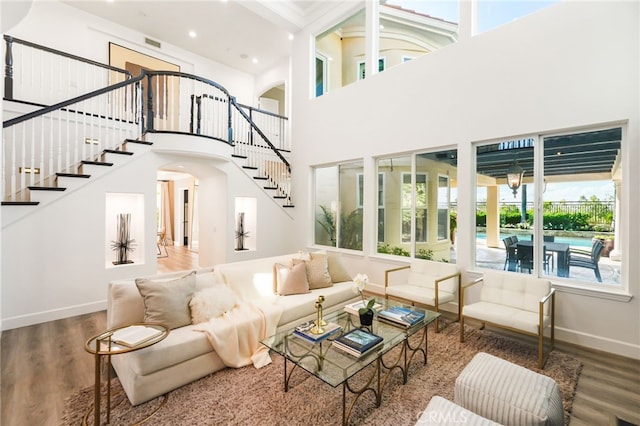 20112 Via Cellini, Porter Ranch, CA 91311 - living area featuring arched walkways, stairway, wood finished floors, baseboards, and a towering ceiling