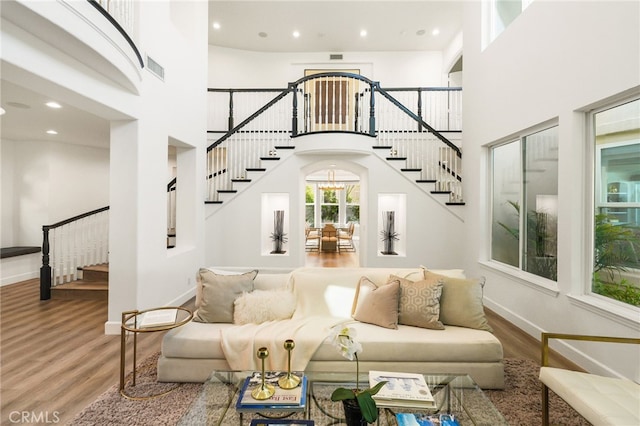 20112 Via Cellini, Porter Ranch, CA 91311 - living area featuring stairs, wood finished floors, baseboards, a towering ceiling, and recessed lighting